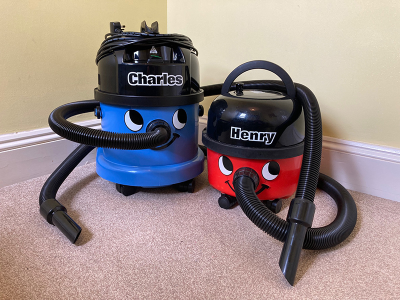 A Charles vacuum cleaner and Henry vacuum cleaner side by side